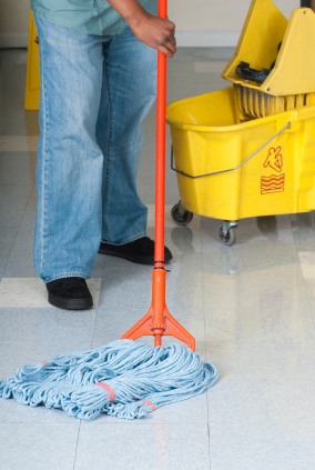 A Plus House & Office Cleaning janitor in Utica, OH mopping floor.